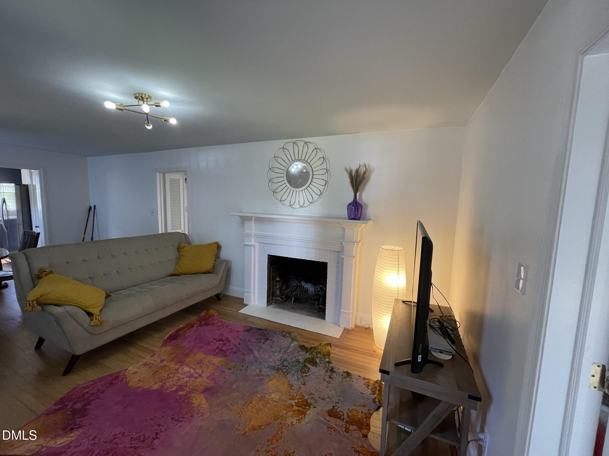 1009 Canterbury Road Raleigh, NC 27607 - Photo 19 of 31 a living room with furniture and a fireplace