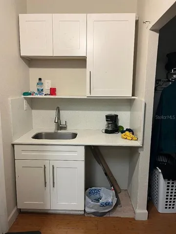 a kitchen with a sink and a refrigerator