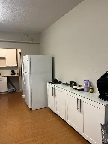 a kitchen with white cabinets and white appliances