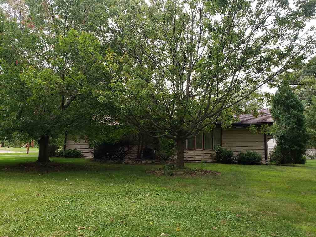 1493 North River Road Oregon, IL 61061 - Photo 2 of 9 a front view of a house with a garden