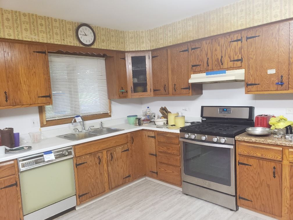 1493 North River Road Oregon, IL 61061 - Photo 3 of 9 a kitchen with a stove sink and cabinets