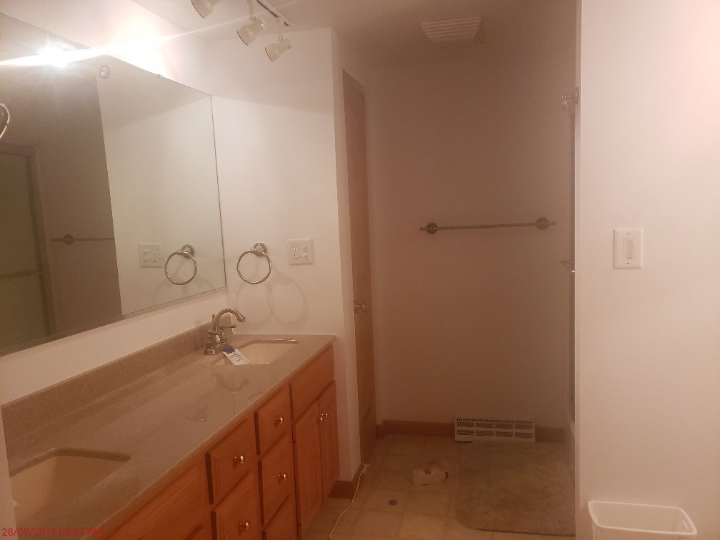 1493 North River Road Oregon, IL 61061 - Photo 6 of 9 a bathroom with a sink and mirror with toilet