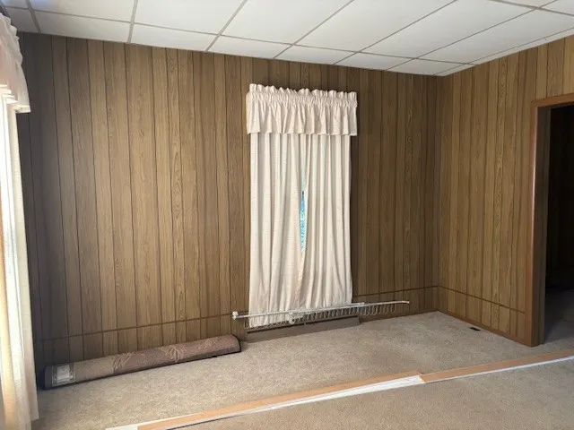 a kitchen with granite countertop a refrigerator a sink stainless steel appliances and cabinets