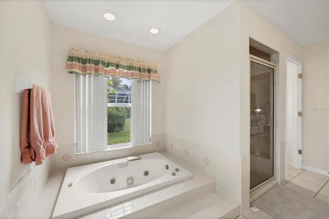 a bathroom with a tub and a shower