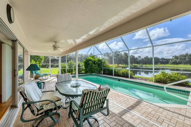 a view of a patio with a table chairs and a yard