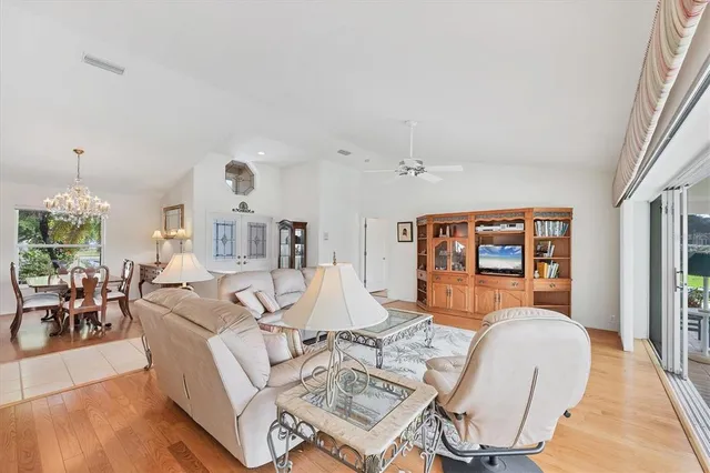 a living room with furniture a table and chairs