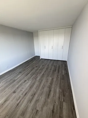 an aerial view of a residential houses with outdoor space and trees