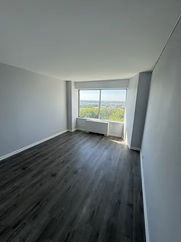 a view of a room with wooden floor