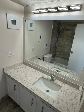 a view of an empty room and wooden floor