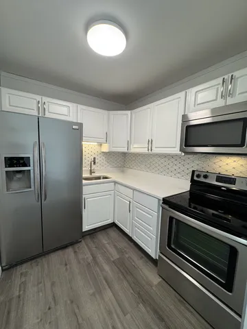 a kitchen with a refrigerator stove and microwave