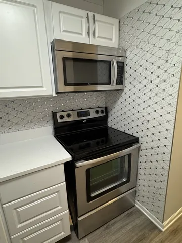 a kitchen with a stove microwave and sink