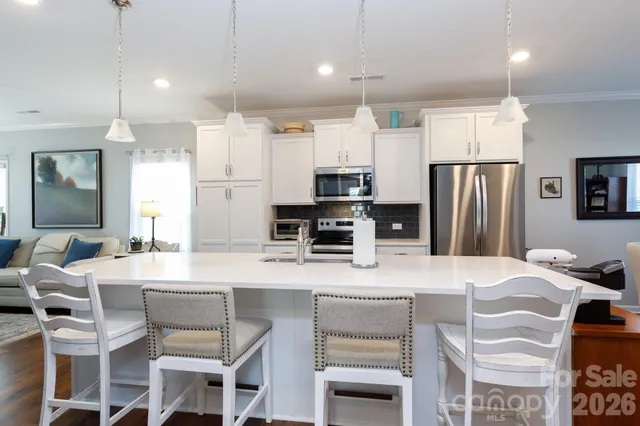 a view of washer and dryer with kitchen in the background