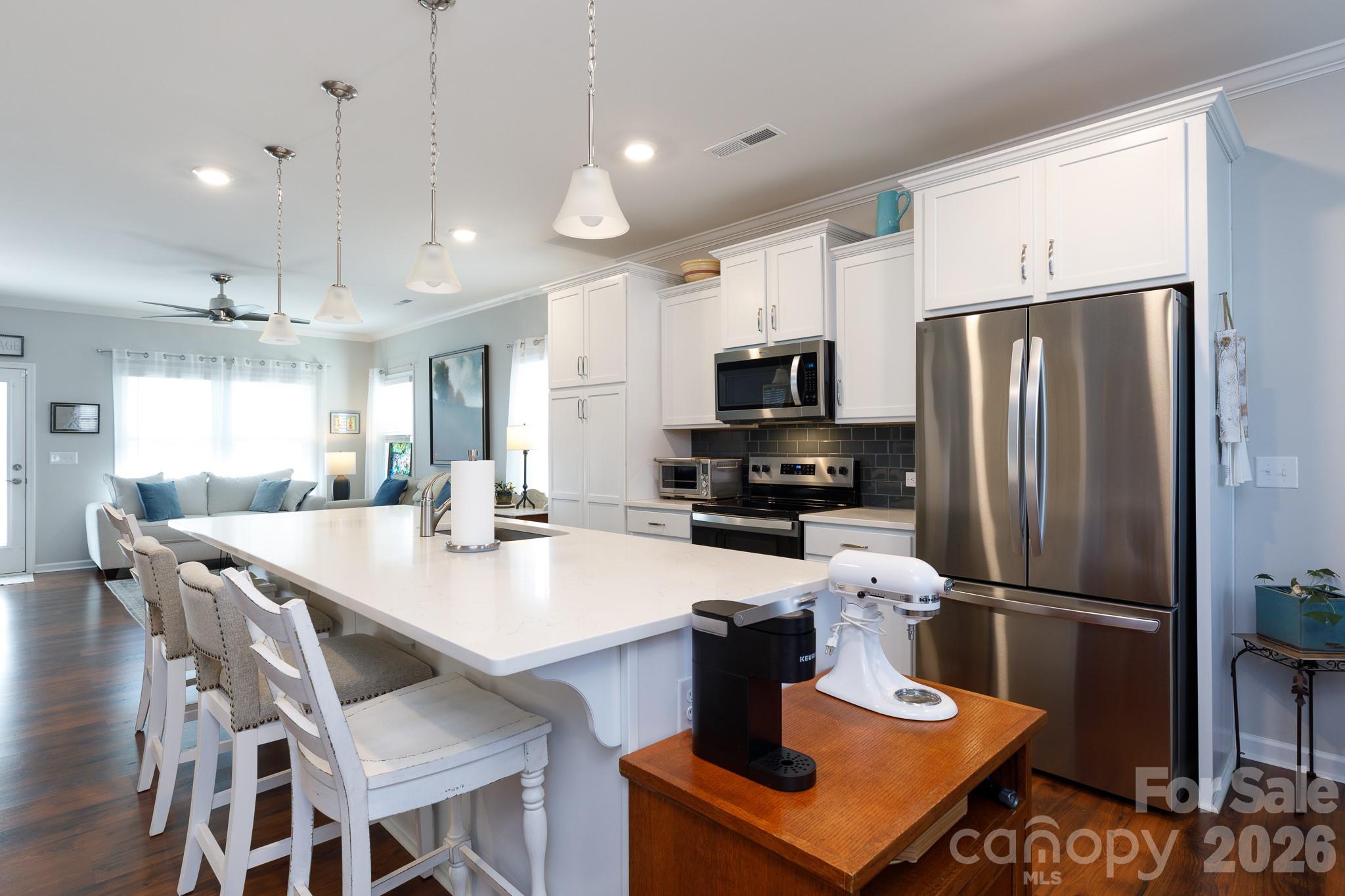 40308 Crooked Stick Lane Lancaster, SC 29720 - Photo 12 of 46 a kitchen with stainless steel appliances granite countertop a refrigerator a stove a sink a dining table and chairs
