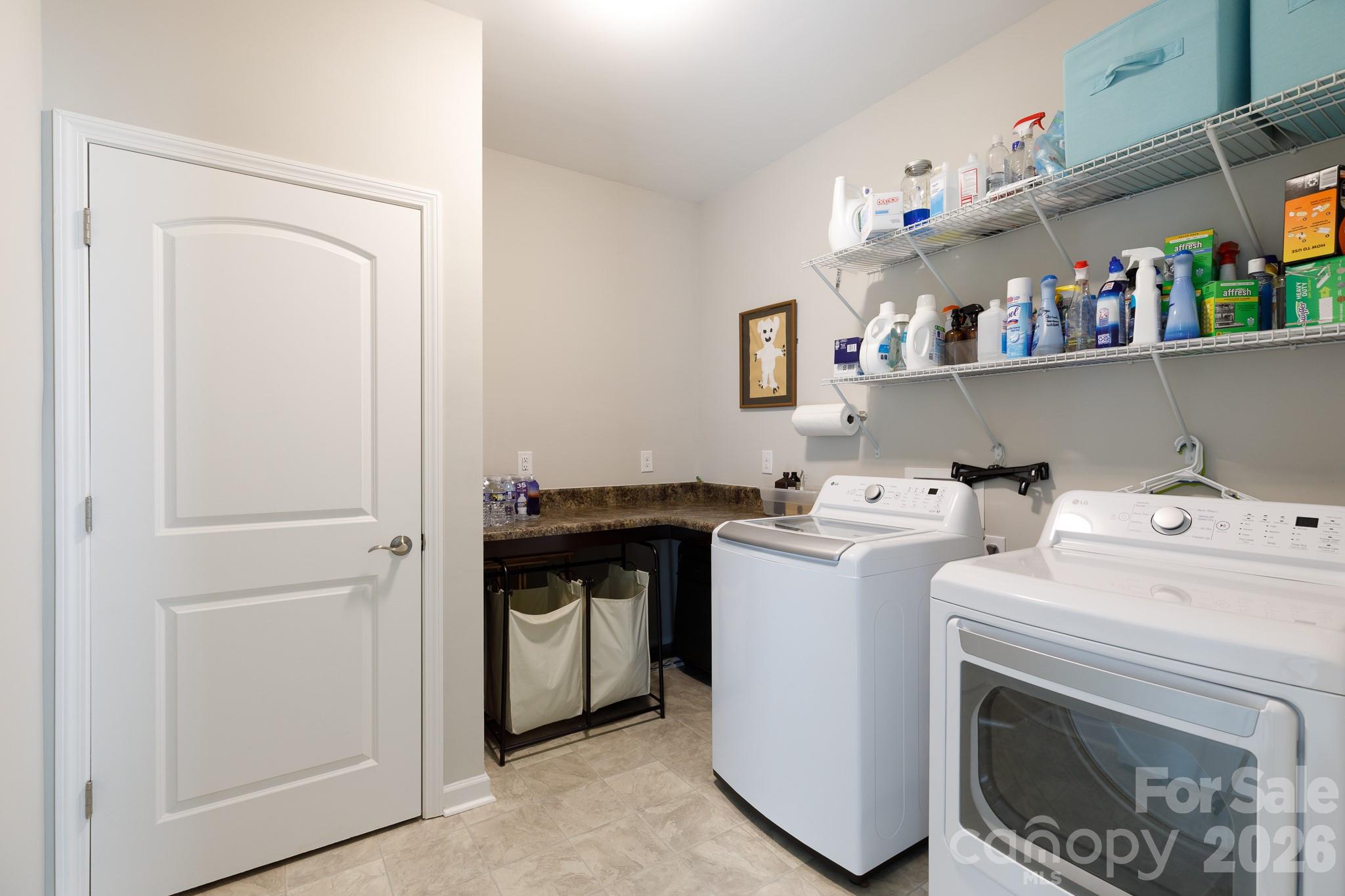 40308 Crooked Stick Lane Lancaster, SC 29720 - Photo 18 of 46 a view of washer and dryer with kitchen in the background