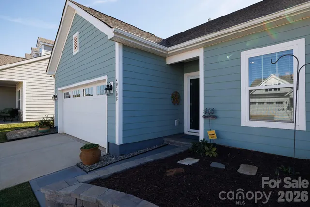 a living room with furniture kitchen view and a window