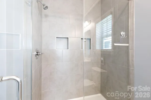 a view of a living room with furniture and floor to ceiling windows