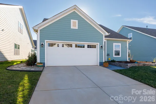 a living room with furniture flat screen tv and window