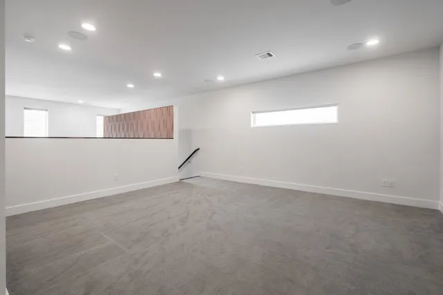 an empty room with entrance and windows