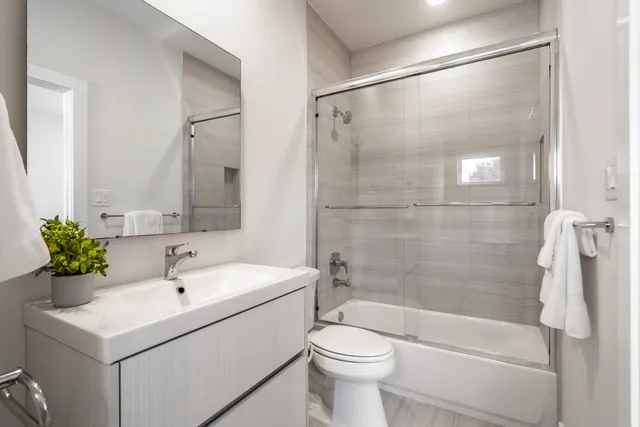 a bathroom with a sink toilet and shower