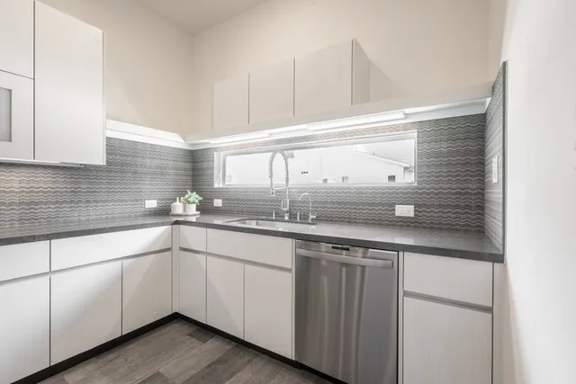 a kitchen with sink and cabinets