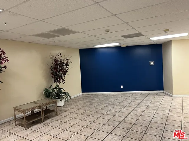 a room with painting and a potted plant