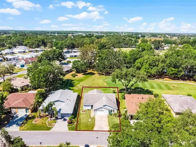 an aerial view of residential houses with outdoor space and ocean view