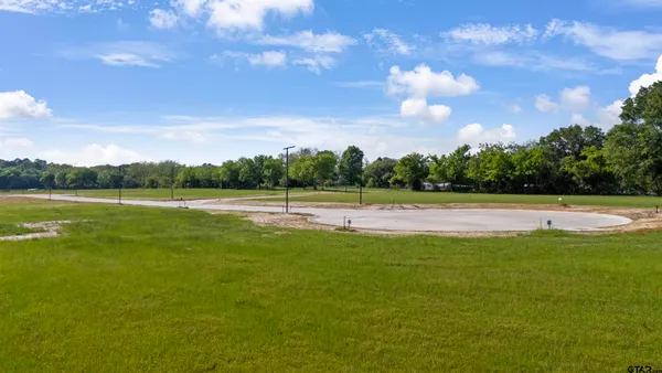 a view of a swimming pool and a yard