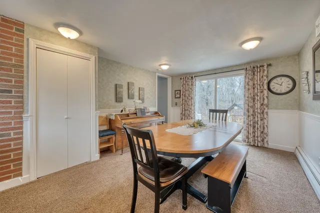 a dining room with furniture and window
