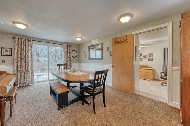 a view of a dining room with furniture and a window