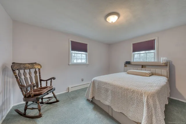 a bedroom with a bed and a chair