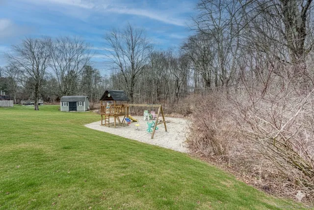 a view of a park with bench and trees