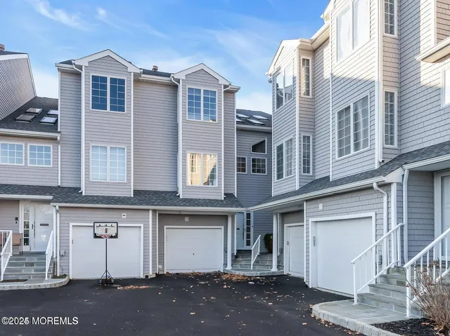 a front view of a house with a parking area