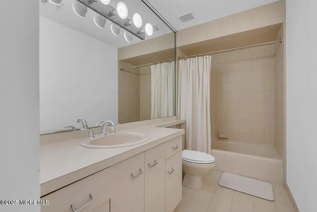 a spacious bathroom with a shower a large mirror and bathtub