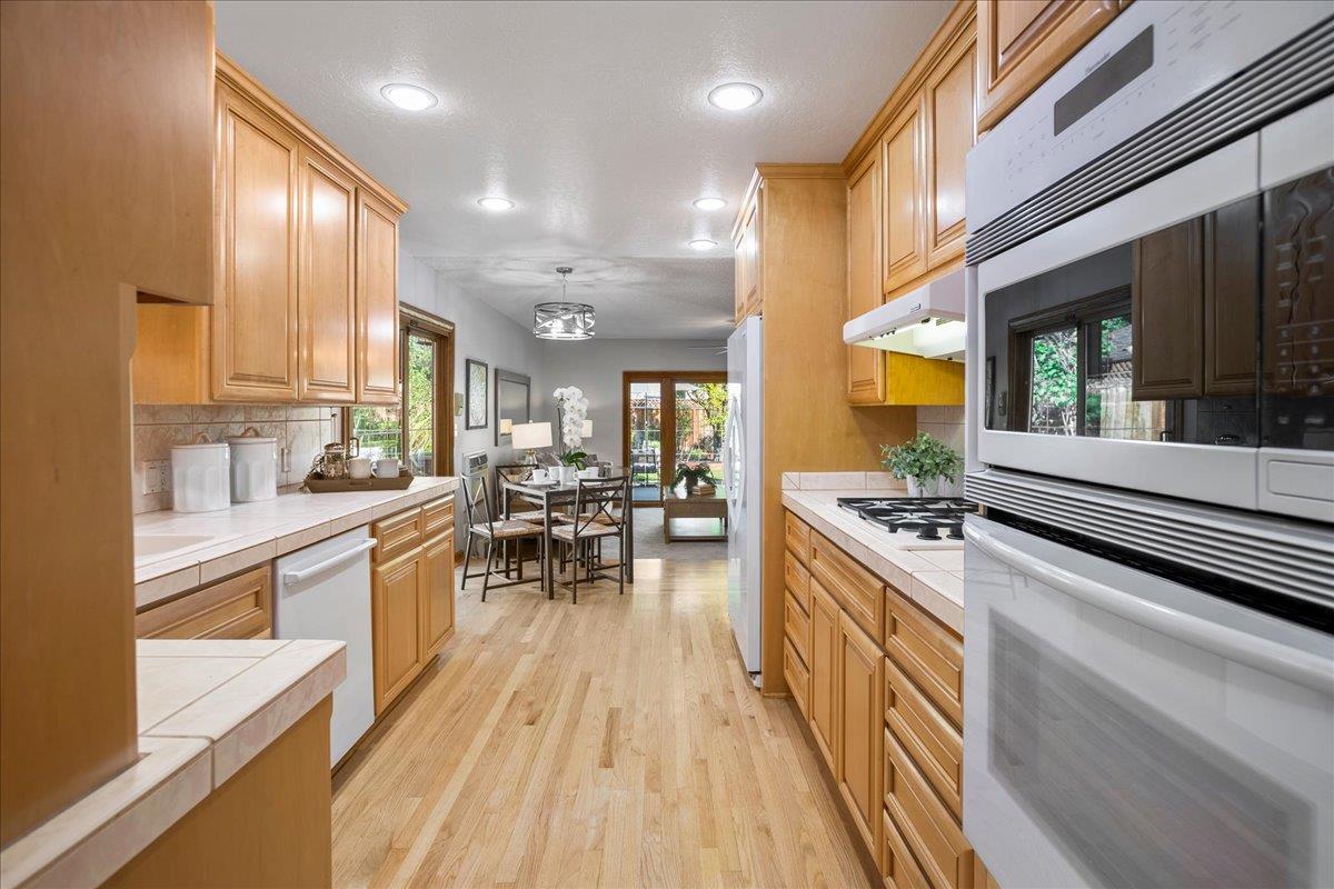 1816 Dry Creek Road San Jose, CA 95124 - Photo 15 of 37 a large kitchen with stainless steel appliances granite countertop a lot of counter space and a wooden floors