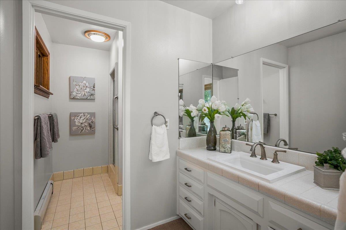 1816 Dry Creek Road San Jose, CA 95124 - Photo 19 of 37 a bathroom with a sink a mirror and a shower
