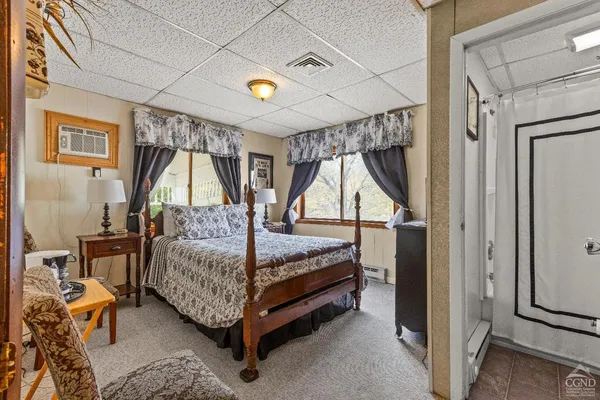 a bedroom with a bed a couch and dresser