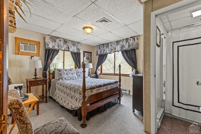 a bedroom with a bed a couch and dresser