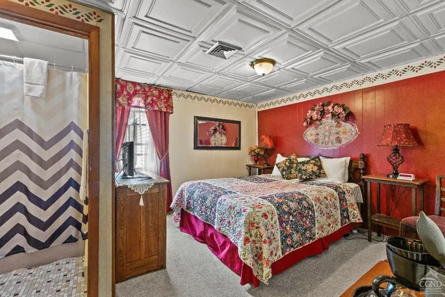 a bedroom with a bed and a table