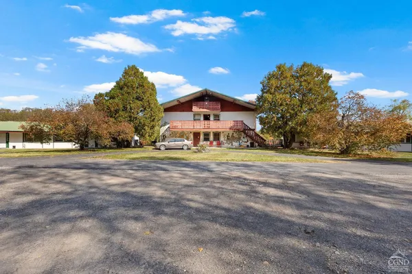 a view of swimming pool with lawn chairs and yard