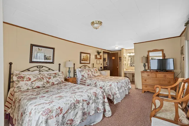 a bedroom with a bed and a flat screen tv