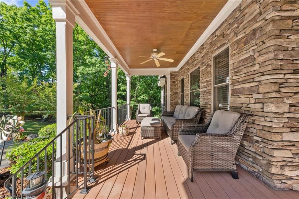 2207 Sierra Trace Road Denton, NC 27239 - Photo 5 of 49 Inviting covered front porch featuring stone accents and peaceful wooded surroundings