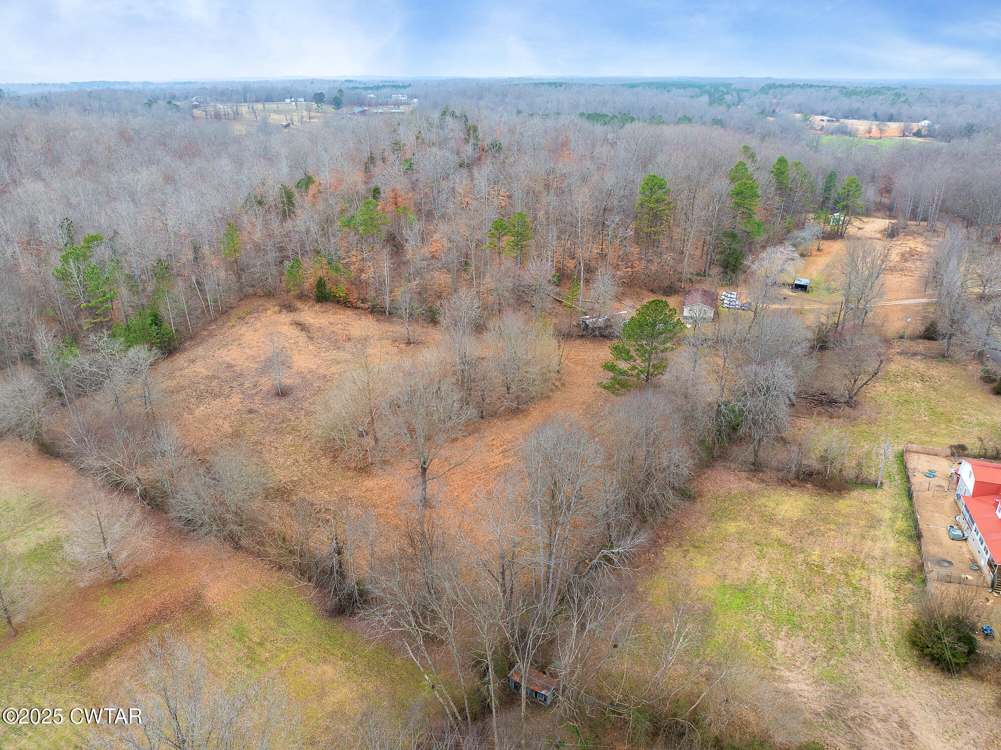 a view of a yard with wooden fence