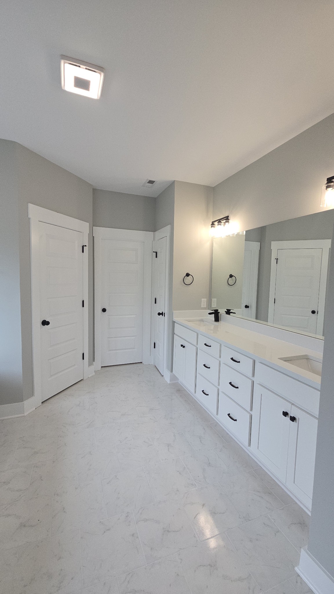 11533 Karo Road Bell Buckle, TN 37020 - Photo 8 of 22 a view of a double vanity sink and a mirror in a room