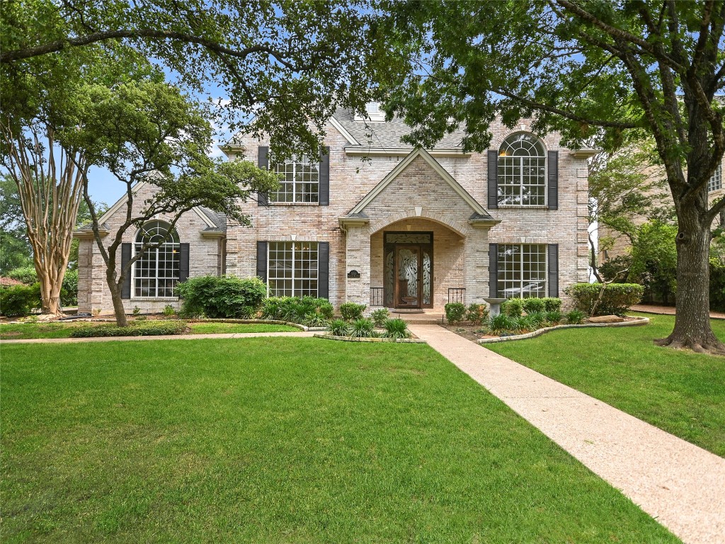 a front view of a house with a yard