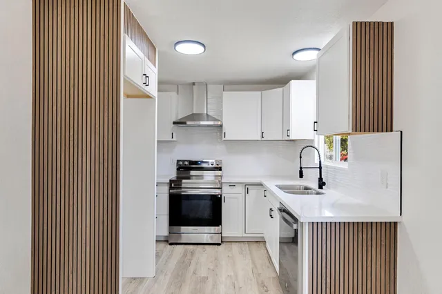 a kitchen with appliances cabinets and a sink
