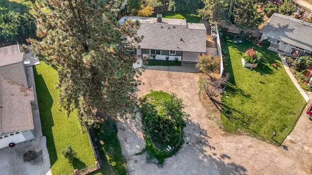 an aerial view of a house with a yard and garden