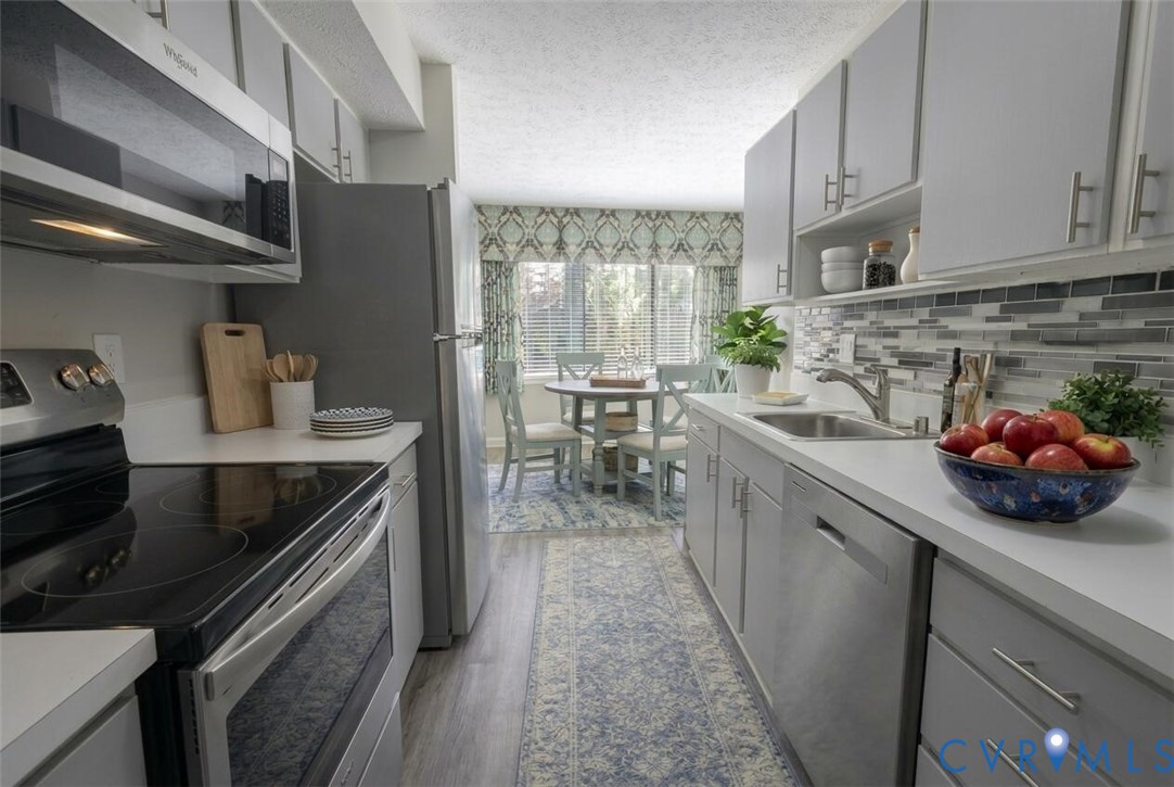 1501 Bronwyn Road, Unit 202 Henrico, VA 23238 - Photo 13 of 22 a kitchen with stainless steel appliances a sink a stove and cabinets