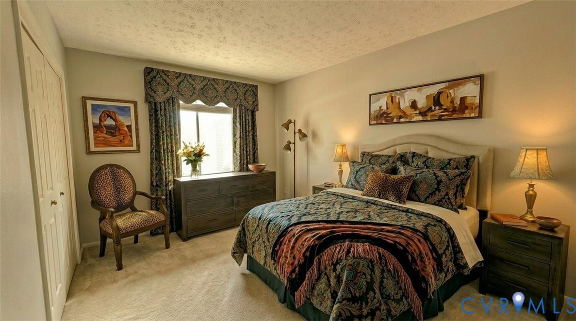 1501 Bronwyn Road, Unit 202 Henrico, VA 23238 - Photo 7 of 22 a bedroom with a bed and a chair