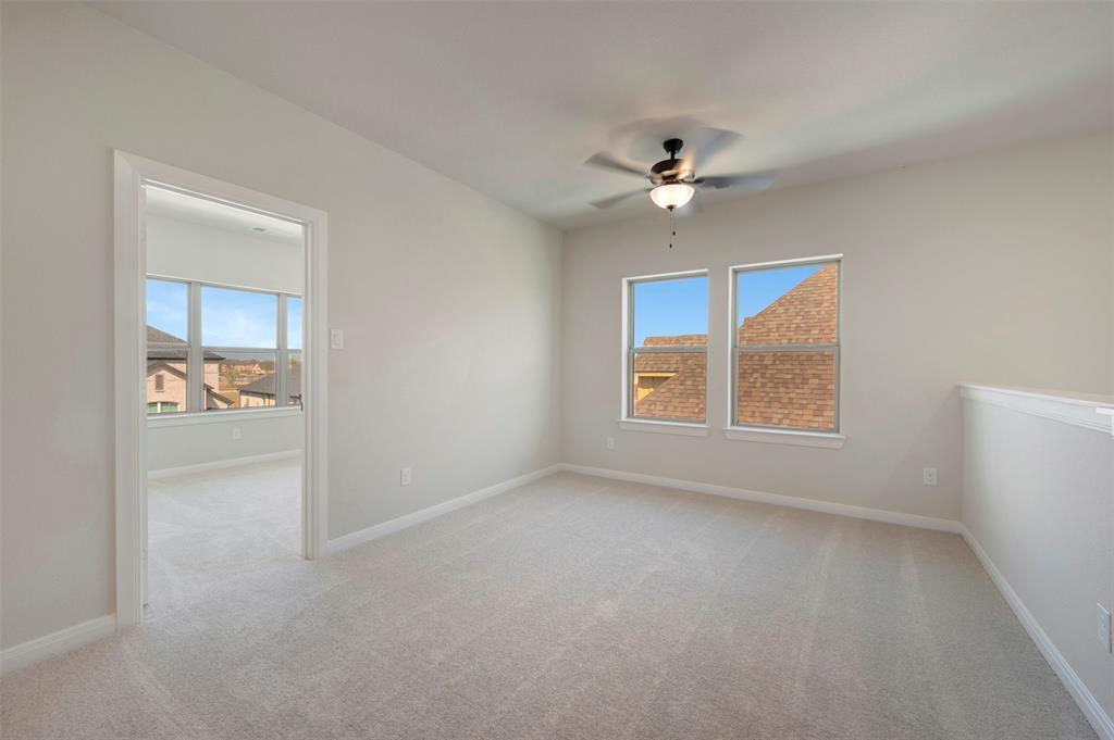 3575 Redbud Flower Trail Venus, TX 76084 - Photo 9 of 36 Spare room featuring light colored carpet, ceiling fan, and healthy amount of natural light