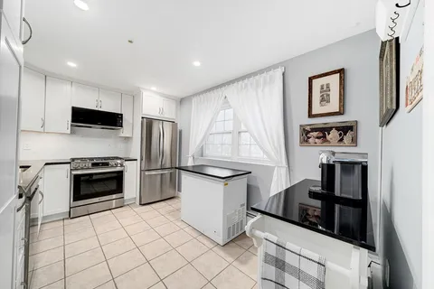 a kitchen with a stove a refrigerator and a sink